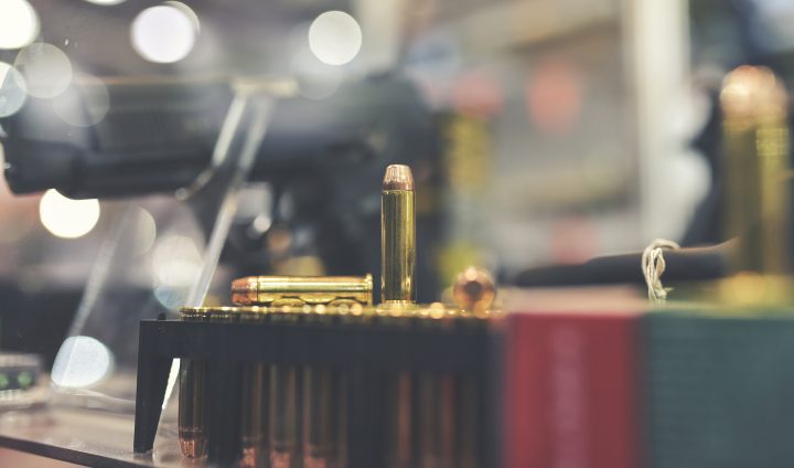 bullets and gun on counter in retail gun store