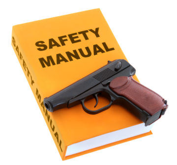 Safety Manual book with gun on white background