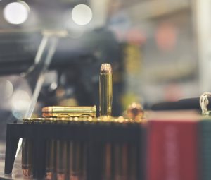 bullets and gun on counter in retail gun store
