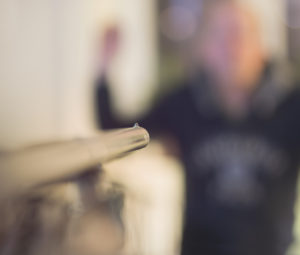 Close up of barrel of shotgun aiming at man with his hands up